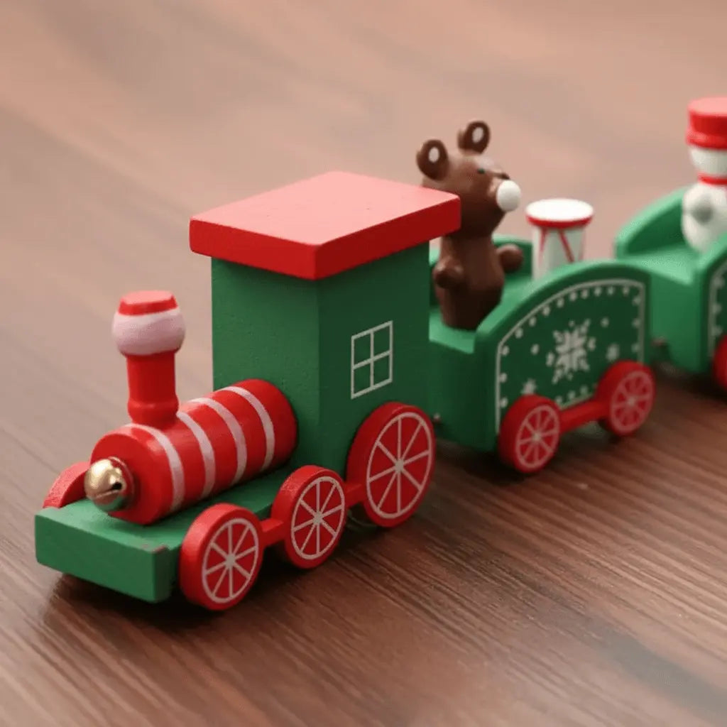 Close-up of handcrafted details on green wooden Christmas train ornament.
