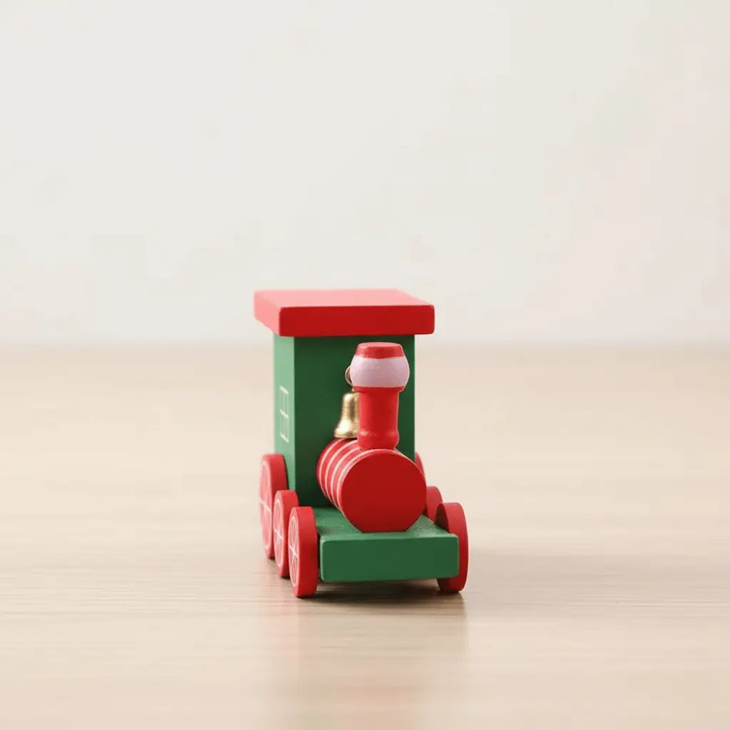 Front view of red and green wooden Christmas train ornament featuring Santa figure on a beige wooden table.