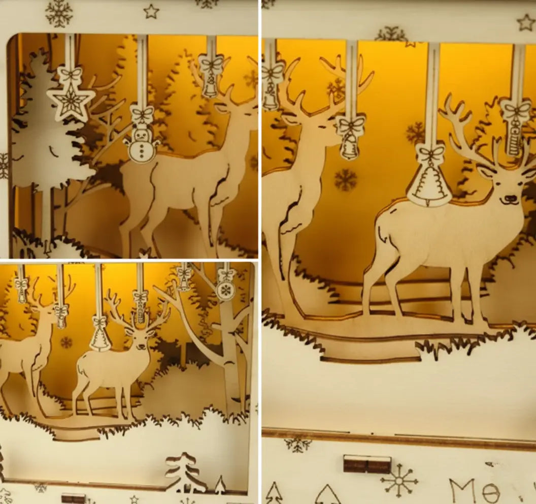 Close-up of layered wooden LED Christmas light box showing reindeer and pine tree details illuminated warmly.